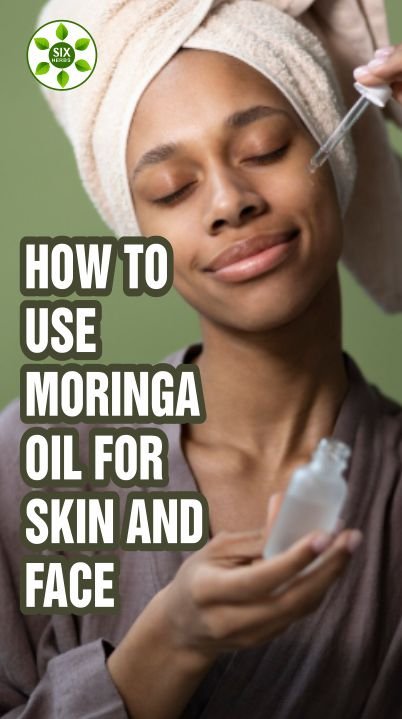 A lady applying moringa oil on her face