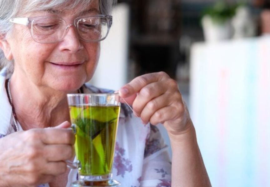 A woman drinking moringa for high blood pressure