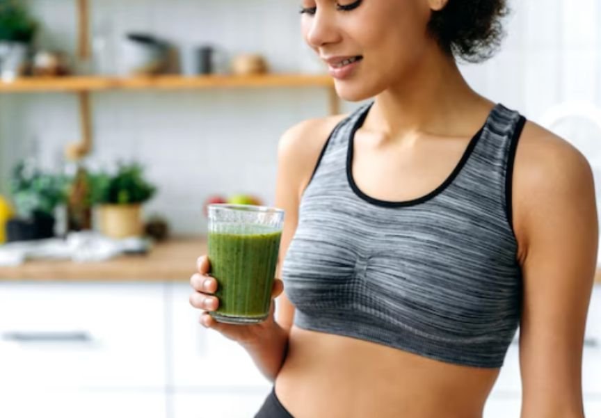 A lady with a glass of moringa for metabolism